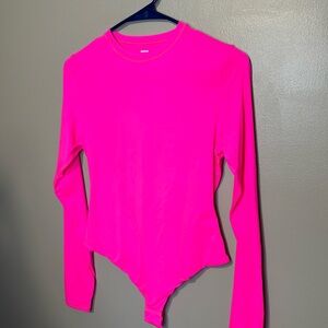Fits everybody long sleeve crewneck bodysuit by skins neon pink is the color
